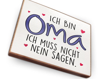 May include: White wooden sign with the text "Ich bin Oma, ich muss nicht nein sagen." in black lettering. The word "Oma" is in purple and there are red hearts scattered around the text.