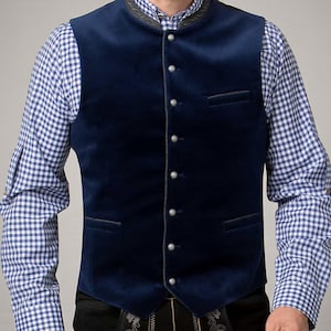 May include: A navy blue velvet waistcoat with silver buttons and a decorative collar. The waistcoat is worn over a blue and white checked shirt. The waistcoat has two small pockets and a tailored fit.