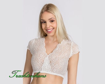 May include: White lace top with short sleeves and a V-neckline. The top is cropped and has a delicate floral pattern.