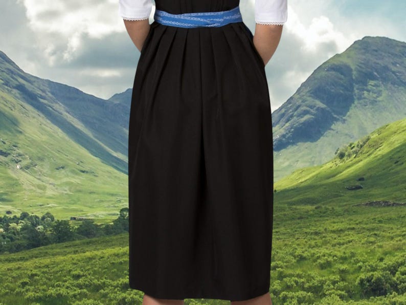 May include: A black dirndl skirt with a blue ribbon waistband. The skirt is pleated and has a simple design.