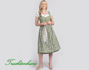 Puede incluir: Un vestido dirndl verde y blanco con estampado floral, con una parte superior de encaje blanco y una cinta gris plateado. El vestido tiene un corpiño abotonado y una falda amplia. El texto "Trachtenhans" está en la esquina inferior izquierda.