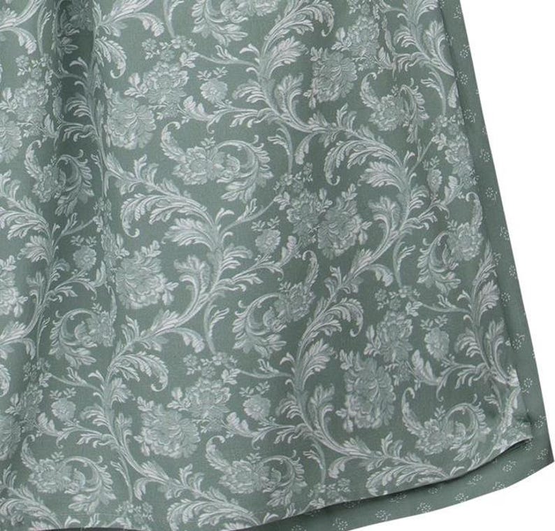 May include: Close-up of a fabric with a repeating floral pattern. The fabric has a sage green background with a white, detailed floral design. The pattern includes flowers, leaves, and swirling vines, creating a classic, elegant look. The fabric appears to be a curtain or drapery.