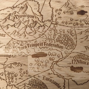 May include: A light brown wooden board with a laser-etched fantasy map. The map features various regions labeled 'Dwargon,' 'Tura Tempest Federation,' 'Tistrary,' 'Milim's Domain,' 'Farmas,' 'Bruning,' and 'Eurazania.'  The map includes mountains, forests, and bodies of water, rendered in a vintage style.  The map's design is reminiscent of a medieval or fantasy setting.