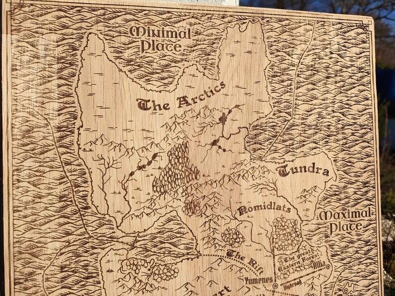 May include: A laser-engraved wooden map features various geographical locations, including Minimal Place, The Arctics, Tundra, Romidlats, and Maximal Place.  The map's style is reminiscent of vintage cartography, with detailed coastlines, rivers, and mountain ranges.  Names of locations are clearly labeled in a stylized font. The Rift and the Great Eastern Forest are also indicated. The wood's light brown color contrasts nicely with the darker brown engraved lines. The overall aesthetic is rustic and fantasy-themed, suitable for tabletop gaming or home decor.