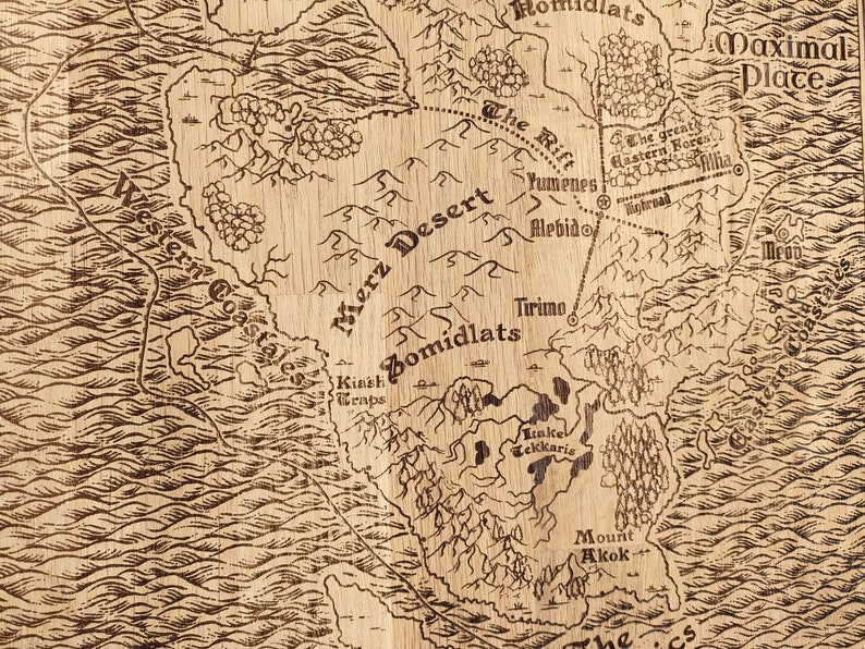 May include: A vintage-style map, reminiscent of a fantasy world, is rendered in sepia tones on a wood-like surface.  The map features various geographical elements, including a Merz Desert, Zomidlats, and the Maximal Place, along with rivers, mountains, and forests.  Names of locations like Yumene, Alebido, Tirino, and Kiash Wraps are inscribed, adding to the map's detailed and intricate design. The overall aesthetic is reminiscent of an antique, hand-drawn map, with a rustic and aged appearance.