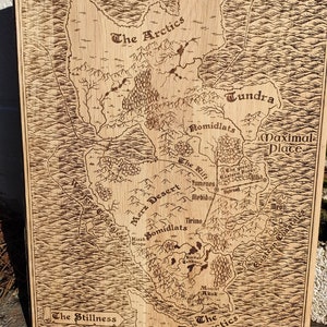 May include: A wood-burned map depicting a fantasy world.  The map features various geographical locations, including The Arctics, Tundra, Merz Desert, Romidlats, and Maximal Place.  Names of locations are clearly labeled.  The map is rectangular and has a light brown wood grain texture. The ocean is represented by wavy lines. The overall style is reminiscent of an antique map.