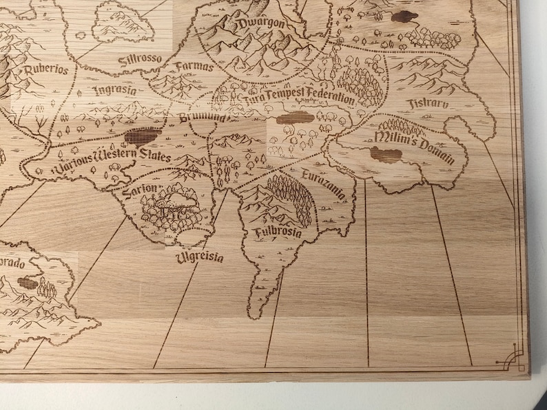 May include: A light brown wooden laser-engraved fantasy world map features various kingdoms and regions, including Ruberios, Sillrosso, Ingrasia, Dwargon, Farmas, Tura Tempest Federation, Brumund, Various Western States, Sarion, Ulgreisia, Fulbrosia, Eurazania, and Jistraru.  The map's intricate details include mountains, forests, and rivers, creating a detailed and immersive fantasy setting.  The names of the regions are clearly engraved, enhancing the map's readability and visual appeal. The map's rustic wooden texture adds to its charm and makes it suitable for tabletop gaming or as a decorative piece.