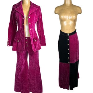 May include: A magenta velvet suit with a blazer, matching pants, and a button-down skirt. The blazer has pockets and buttons, and the pants have a flared leg. The skirt is color-blocked with magenta and black panels.