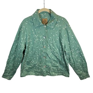 May include: A long-sleeved button-down jacket in a muted teal green color featuring a repeating white pattern of thin, wavy lines and small leaf-like shapes. The jacket includes a classic collar, five front buttons, and two lower patch pockets.