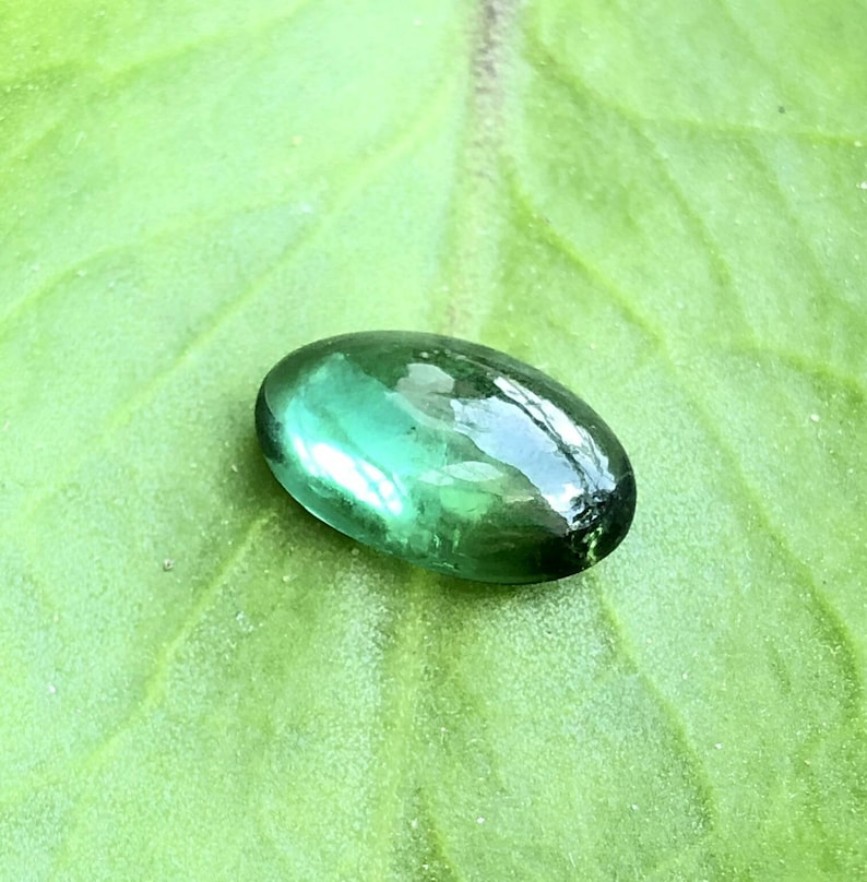 Natural\u00a0 green tourmaline Cabochon semiprecious stone in oval shape\u00a0