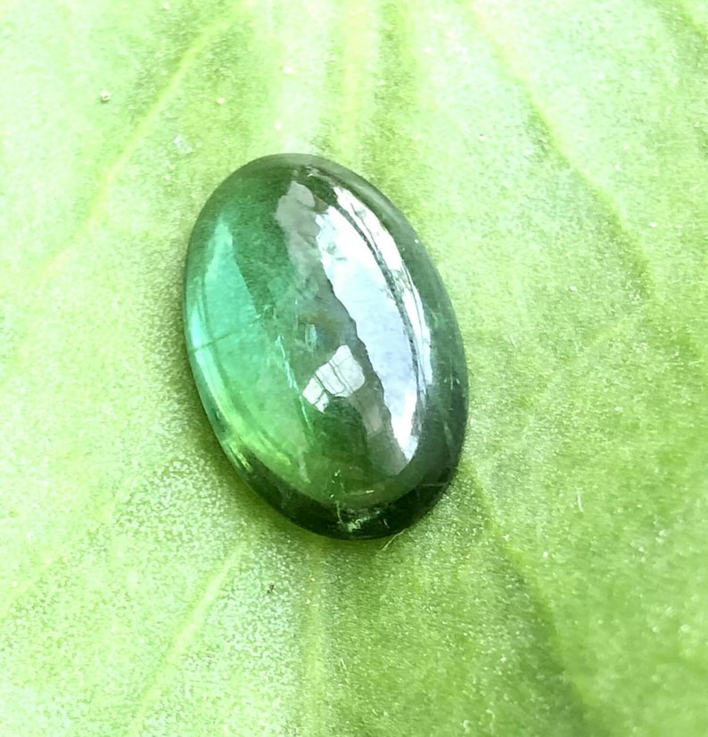 Natural\u00a0 green tourmaline Cabochon semiprecious stone in oval shape\u00a0