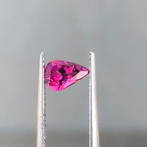 Natural rubilite tourmaline semiprecious gemstone in pear shape .