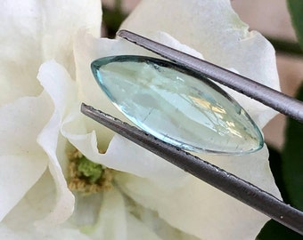 Natural tourmaline cabochon like aquamarine color semiprecious gemstone in marquis shape.
