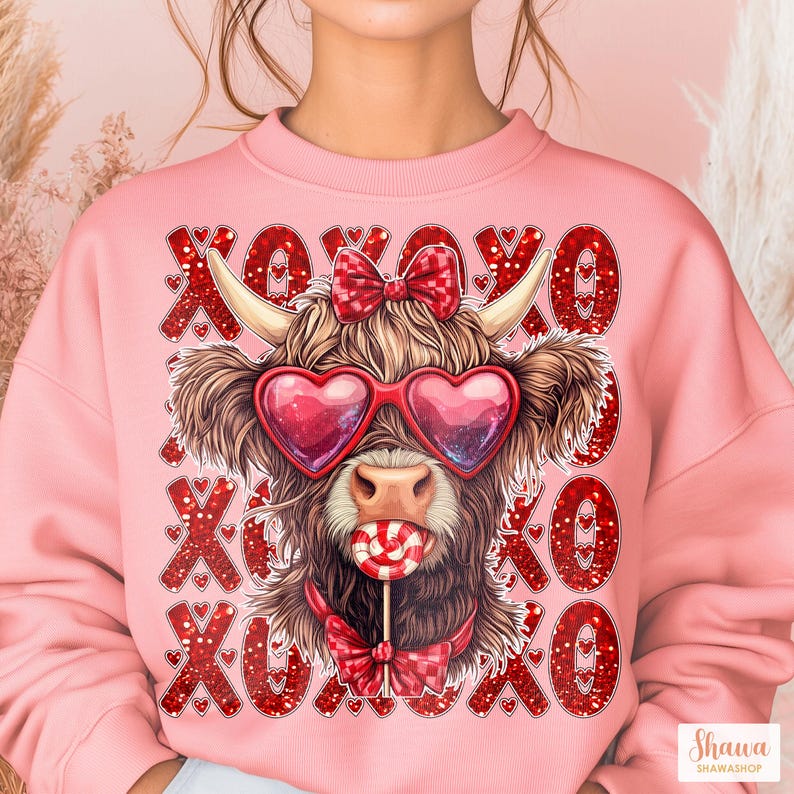May include: Pink sweatshirt with a red glitter XOXO pattern and a cartoon Highland cow wearing heart-shaped sunglasses and a red bow, holding a lollipop.