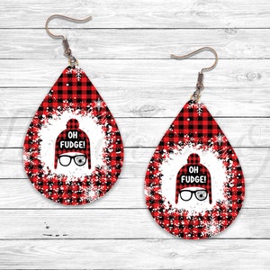 May include: Red and black plaid teardrop shaped earrings with a white background and a cartoon image of a person wearing a winter hat and glasses with the text "Oh Fudge!"