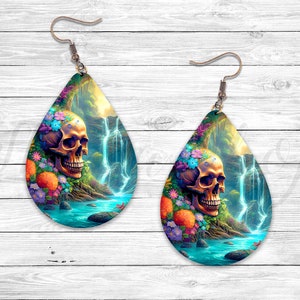 May include: A pair of teardrop-shaped earrings with a colorful skull and waterfall design. The earrings are made of metal and have a silver finish.
