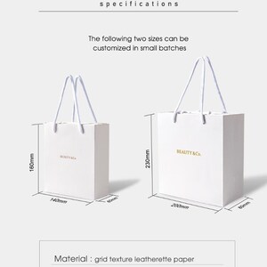 May include: Two white paper shopping bags with rope handles. The smaller bag is 160mm high, 140mm wide, and 60mm deep. The larger bag is 230mm high, 200mm wide, and 80mm deep. Both bags have the text "BEAUTY & Co." in gold.