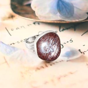 Könnte beinhalten: Rustikales Holzschild mit dem Text "Welcome to our home" in handschriftlichem Stil. Das Schild hat eine Used-Optik und ein schlichtes, einladendes Design, ideal für eine Veranda oder einen Eingangsbereich.