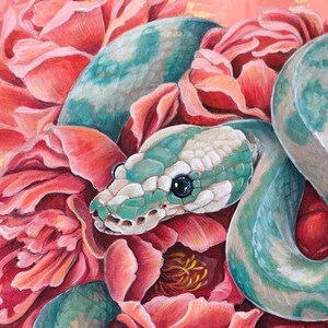 May include: An original painting of a turquoise and white snake coiled among pink peonies. The snake's head is detailed with black eyes and a white and turquoise pattern. The background is a soft pink with gold accents.
