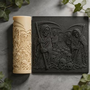May include: A cylindrical cream-colored roller and a rectangular black flat plate, both featuring a detailed relief carving of multiple hooded grim reaper figures holding scythes, standing over a dense field of human skulls and scattered bones.