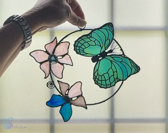 Stained glass butterfly and flowers in a ring