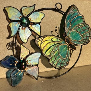 Stained glass butterfly and flowers in a ring