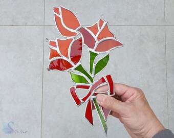May include: A stained glass bouquet of red tulips with green leaves and a red bow.
