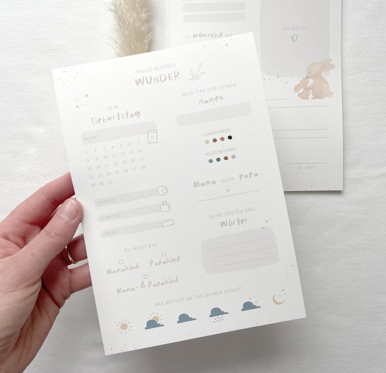May include: A printable baby memory tracker with a light blue background and a cute bunny illustration. The tracker includes sections for the baby's birthday, hair and eye color, first words, and the weather on the day of their birth.