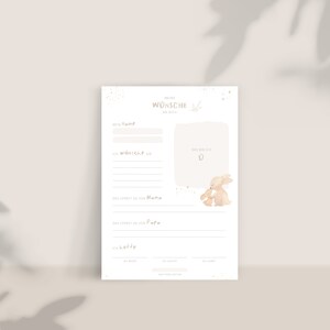 May include: A printable baby shower or new baby gift card with a watercolor illustration of two bunnies. The card has spaces to write the baby's name, wishes for the baby, what the baby will learn from mom and dad, and hopes for the baby's future. The card has the text "Meine W&uuml;nsche an dich" which translates to "My wishes for you".