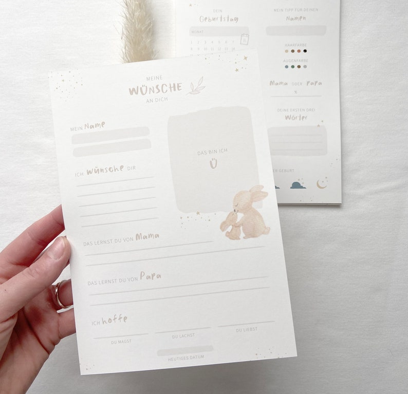 May include: A printable baby shower or new baby gift card with a cute illustration of two bunnies. The card has spaces to write the baby's name, the date of birth, and other wishes for the baby.