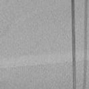 May include: A black and silver thread spool holder with a large white spool of thread. The holder has a circular base and a vertical arm with a curved top. The thread spool is centered on the base.