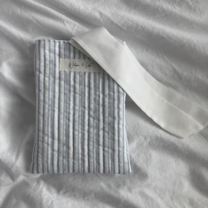 Kindle sleeve, e-reader cover, padded Kindle case, ribbon tie Kindle sleeve, handmade Kindle cover, elegant Kindle sleeve, fabric e-reader case, custom Kindle sleeve, gift for book lovers, travel Kindle pouch