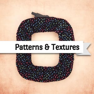 May include: A black cover with a colorful teardrop pattern, wrapped around an object. The text "Patterns & Textures" is displayed on a white banner across the center of the image.