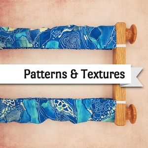 May include: Two blue fabric pieces with white patterns are attached to a wooden frame. The fabric has a map-like design. The frame is made of light-colored wood. The text "Patterns & Textures" is displayed on a white banner.