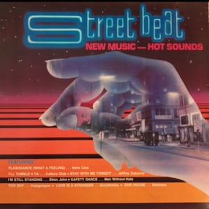 May include: Album cover for "Street Beat: New Music - Hot Sounds." The image features a neon blue title over a hand-shaped graphic with a city scene overlay. The bottom of the cover lists song titles and artists, including "Flashdance" and "I'm Still Standing."