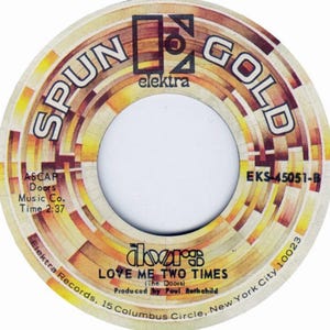 May include: A vintage vinyl record label for "Love Me Two Times" by The Doors. The label features a circular design with the words "SPUN GOLD" and "elektra" in a retro font. Additional text includes the song title, artist, and production details.