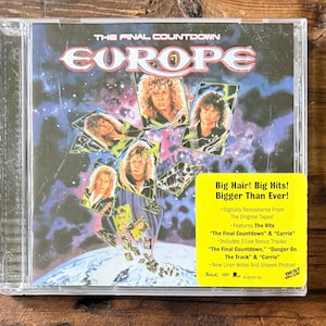 May include: A CD of the album "The Final Countdown" by the band Europe. The album cover features the band members' portraits and the band's name in a stylized font. A yellow sticker on the case reads "Big Hair! Big Hits! Bigger Than Ever!"