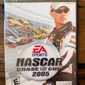 May include: A PlayStation 2 video game case for NASCAR Chase for the Cup 2005. The cover features a race car driver in a racing suit and sunglasses, with race cars in the background. The game is rated "E" for Everyone.