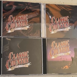 May include: Four CD cases with a black background and a red and white logo that says "Classic Country" with a year range. The first case says "1950-1959", the second says "1960-1964", the third says "1965-1969", and the fourth says "Great Story Songs".