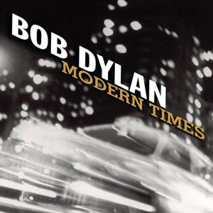 May include: Album cover for Bob Dylan's "Modern Times." The image is a black and white photograph with blurred streaks of light and a cityscape in the background. The album title and artist name are in white and gold lettering.