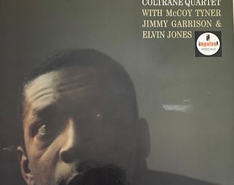 Op de afbeelding: Albumhoes voor "John Coltrane Quartet Ballads" met een portret van een man. De albumtitel en artiestennamen staan in sierlijke letters. Het Impulse! Records-logo is zichtbaar. De plaat is een stereo-opname.