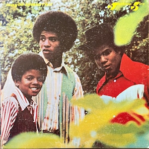 May include: A vintage vinyl record cover featuring the Jackson 5 with the text maybe tomorrow and Jackson 5 printed in yellow. The image shows three individuals with afro hairstyles, one wearing a red shirt with fringe, and others in striped shirts.