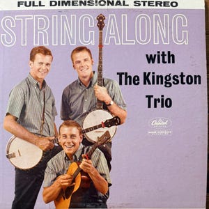 May include: Album cover for "String Along with The Kingston Trio" featuring three men with banjos and guitars. The album cover is purple with white text and the Capitol Records logo.