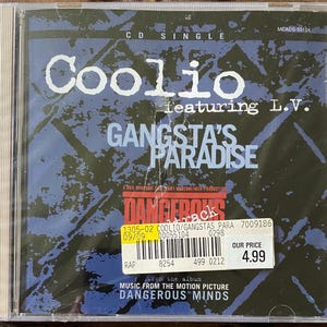 May include: A CD single of Coolio featuring L.V.'s "Gangsta's Paradise" from the movie "Dangerous Minds." The CD case has a blue and black background with the song title in large, light blue letters.