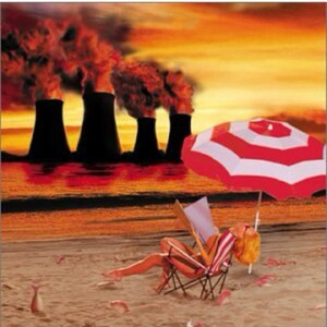 May include: A woman relaxes on a beach chair under a red and white striped umbrella.  The beach is sandy and there are several red fish on the sand.  In the background, there are several large industrial smokestacks emitting black smoke.