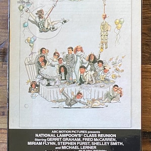 May include: A VHS tape for National Lampoon's Class Reunion. The cover features a colorful illustration of a class reunion scene with cartoon figures and the film's title in green and red. The bottom of the tape has the film's credits.