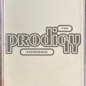 May include: A cassette tape with the band The Prodigy's album "Experience" printed on the front. The band's name is in a bold, stylized font with a black outline.