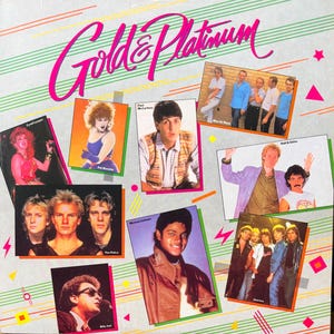 May include: A vinyl record cover titled Gold & Platinum featuring a collage of various musical artists including Cyndi Lauper, Pat Benatar, Paul McCartney, Men At Work, The Police, Michael Jackson, Hall & Oates, and Journey against a light background.
