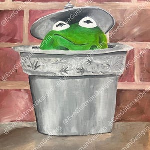 Puede incluir: Pintura de una rana verde asomándose de un cubo de basura plateado con la tapa entreabierta. El fondo presenta una pared de ladrillos rojos. Se aprecia el nombre del artista. Obra de arte caprichosa.