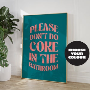 May include: A teal blue poster with the text "PLEASE DON'T DO COKE IN THE BATHROOM" in pink lettering. The poster is framed in gold and has a black circle with the text "CHOOSE YOUR COLOUR" in white lettering.